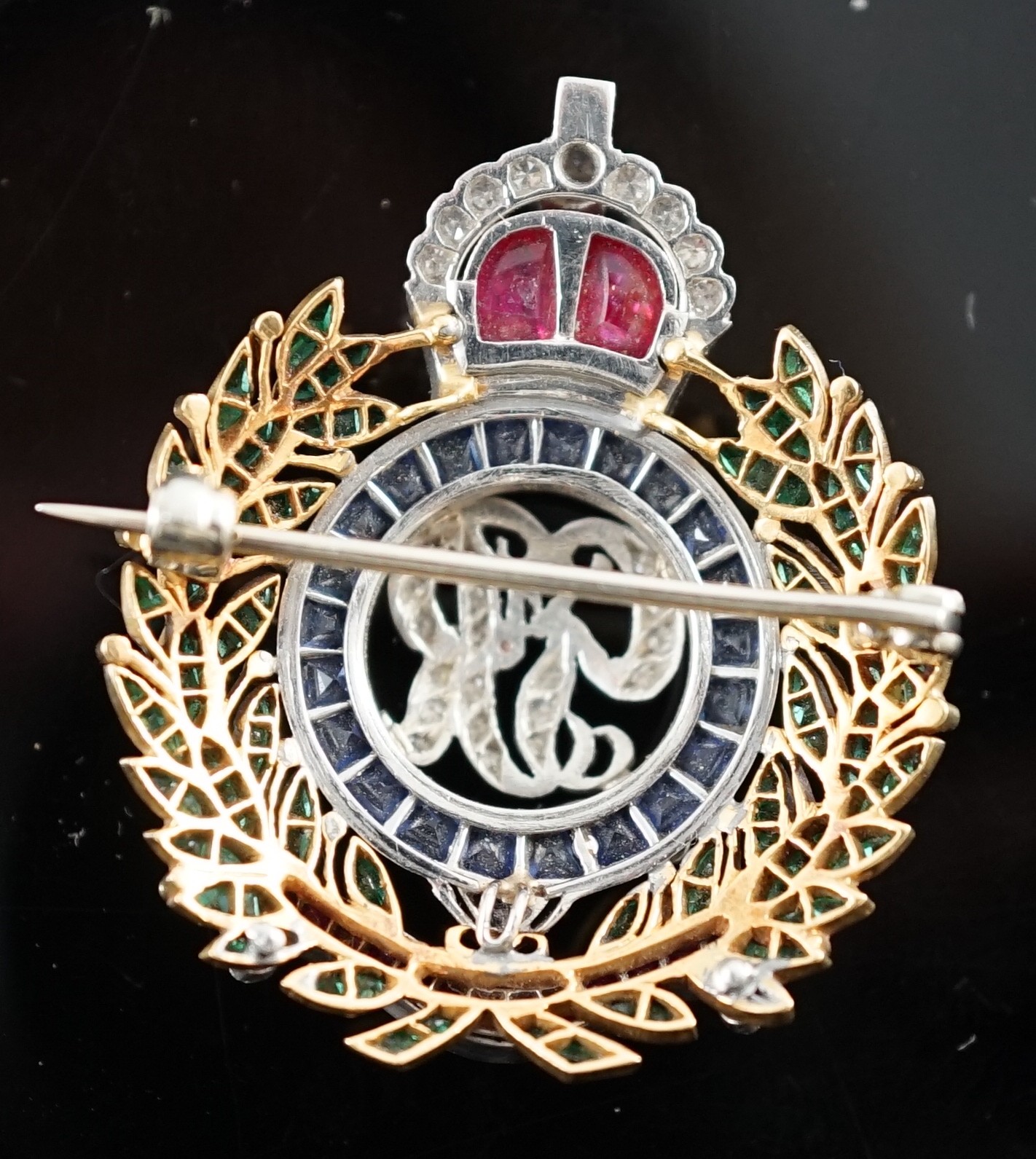 A gold and platinum, ruby, sapphire, emerald and diamond chip set Royal Engineers brooch